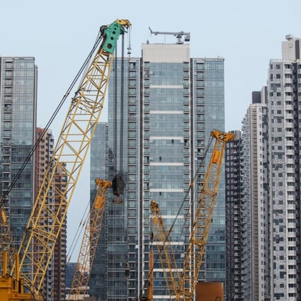 Cranes at a construction site at the former Kai Tak airport area in front of residential buildings in Hong Kong, on Saturday, July 21, 2018. Photo: Paul Yeung/Bloomberg