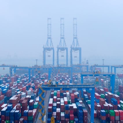 Containers and trucks are seen on a snowy day at an automated container terminal in Qingdao port, Shandong province, China December 10, 2018. Photo: Reuters