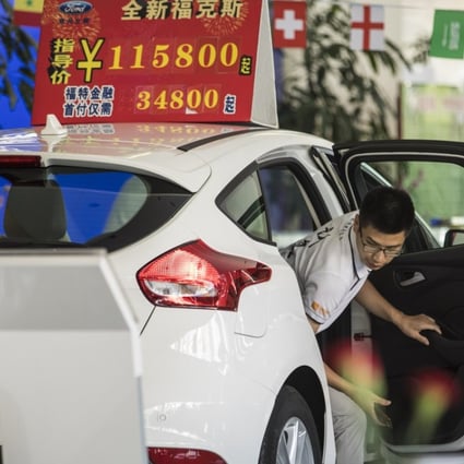 A customer steps out of a Ford Motor Co. vehicle on display at a Ford dealership in Shanghai, China. The US-China trade war will take a toll on companies from both sides, with some tariffs in place and the potential to escalate into consumer boycotts. Photo: Bloomberg