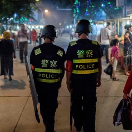 Police patrol a market near the Id Kah Mosque in Kashgar, Xinjiang. Photo: AFP