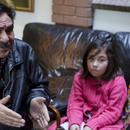Mir Aman with his daughters Shahnaz (right) and Shakeela. Photo: AP
