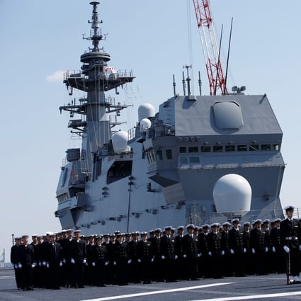 Members of the Japan Maritime Self-Defence Force attend a handover ceremony for the latest Izumo-class helicopter carrier JS Kaga (DDH-184) in Yokohama on March 22. Photo: Reuters