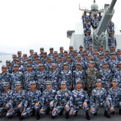 President Xi Jinping (centre, front row) with soldiers on a PLA Navy ship in the South China Sea. Photo: AP
