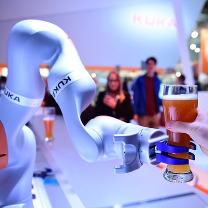 A Kuka robot serves beer at the Hanover Fair in Germany on April 24, 2017. The acquisition of the German industrial robotics manufacturer by appliance maker Midea in 2016 has led to concerns about investments by Chinese companies in Europe. Photo: AFP