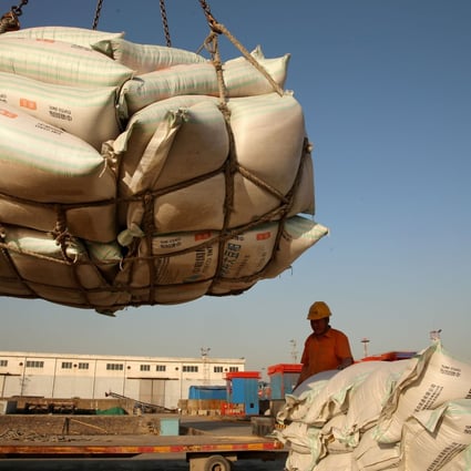 Workers transport imported soybean products at a port in Nantong, Jiangsu. Photo: Reuters