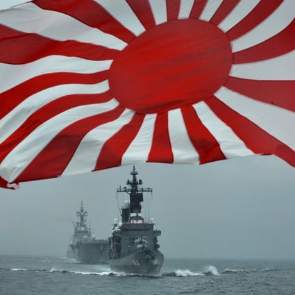 File photo of a flag of the Japanese Maritime Self-Defence Force and escort ships Kurama and Hyuga off Sagami Bay, Kanagawa prefecture. Photo: AFP