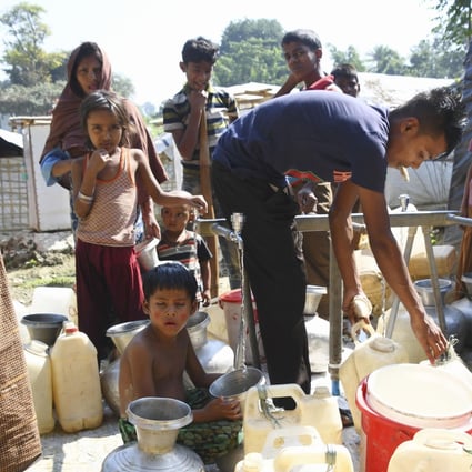 Rohingya Muslims fill water containers at a refugee camp in Cox's Bazar. Photo: Kyodo
