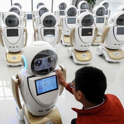 An employee checks robots used for customer service at a factory in eastern China. The draft law encourages tech cooperation based on voluntary principles and commercial rules. Photo: AFP