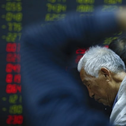 An investor reacts as he and investors monitor stock prices on October 24, 2018, at a brokerage house in Beijing. Photo: Associated Press