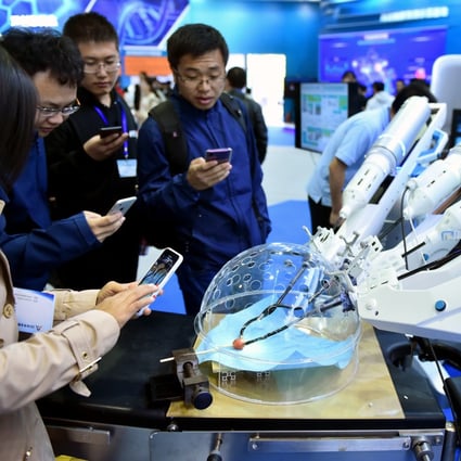 Visitors watch a robot performing surgery during the 2018 national mass innovation and entrepreneurship week in Beijing in October. Photo: Xinhua