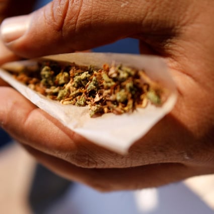 A man prepares a mix of tobacco and marijuana for smoking. Photo: Reuters