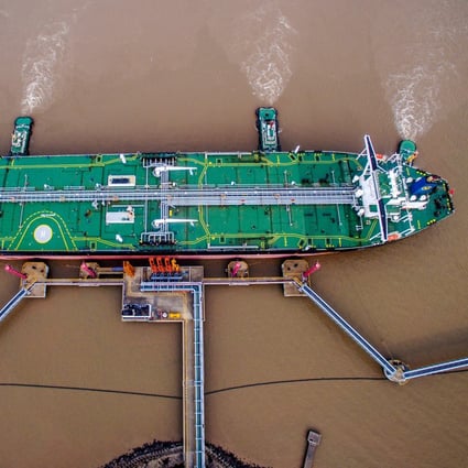 An oil tanker unloads crude at a terminal in Zhejiang province. Private refiners received quotas for 70.65 million tonnes of imports – more than 20 per cent lower than a year ago. Photo: Reuters