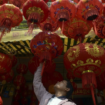 A Cambodian man looks at Chinese Lunar New Year lanterns at a shop in Phnom Penh. Photo: AFP
