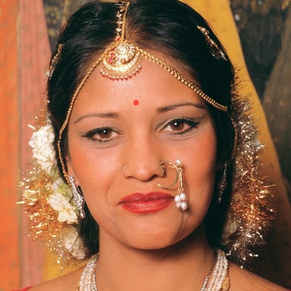 An Indian bride wears nose jewellery. Hindus have a piercing on the left side of the nose in honour of the marriage goddess, Parvati. Photo: Alamy