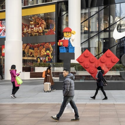Pedestrians walk past a Lego installation in Shanghai, China, on Friday, Dec. 28, 2018. China announced plans to rein in the expansion of lending by the nation's regional banks to areas beyond their home bases, the latest step policy makers have taken to defend against financial risk in the world's second-biggest economy. Photo: Bloomberg