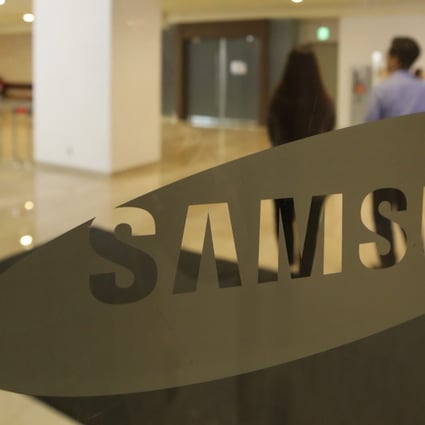 People walk past a Samsung Electronics logo at its headquarters in southern Seoul, South Korea. Photo: EPA