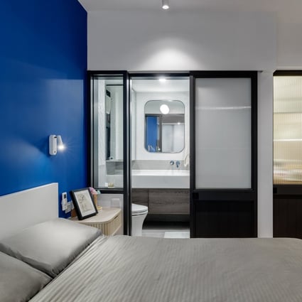The master bedroom in Carmen and Callum Tse’s Tin Hau apartment boasts a bold, blue feature wall. Photography: Steven Ko