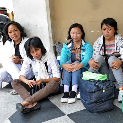 Foreign domestic workers in Singapore have reported being overworked, receiving verbal abuse, not having enough food, and having to give their employers massages. Photo: AFP