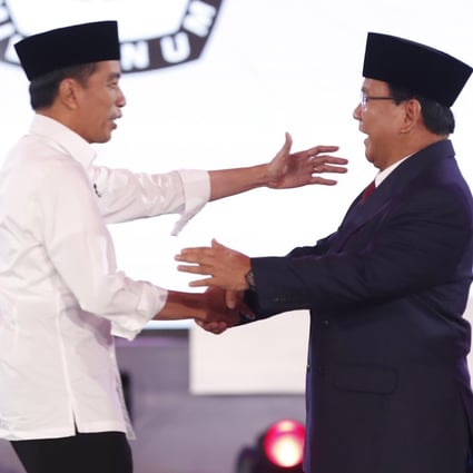 Joko Widodo (left) shakes hand with presidential candidate Prabowo Subianto before the first debate in Jakarta, Indonesia, on January 17. Photo: EPA