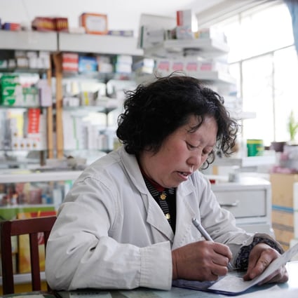 Beijing has moved to cut prices of drugs and improve their efficacy and safety. Here a woman works at the pharmacy of a state-owned hospital in a town in Hebei province, China, in this photo taken in 2008.