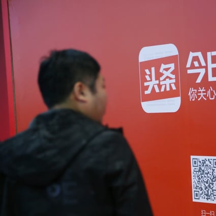 A man walks past an advertisement for Bytedance's news feed platform Toutiao in Beijing. Photo: Reuters
