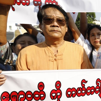 Protesters hold placards reading “Save the Irrawaddy” oppose the Myitsone dam project. Photo: EPA
