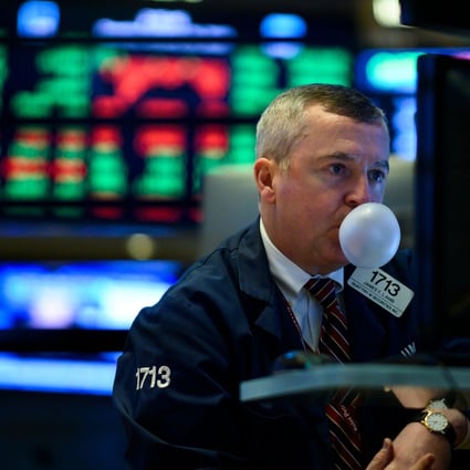A trader blows a bubble with chewing gum ahead of the closing bell on the floor of the New York Stock Exchange on January 29, 2019. Photo: Agence France-Presse