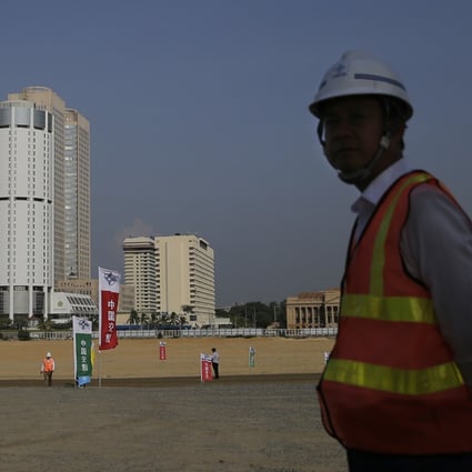 A Chinese construction worker stands on land that was reclaimed from the Indian Ocean for the Colombo Port City project in Sri Lanka’s capital. Photo: AP