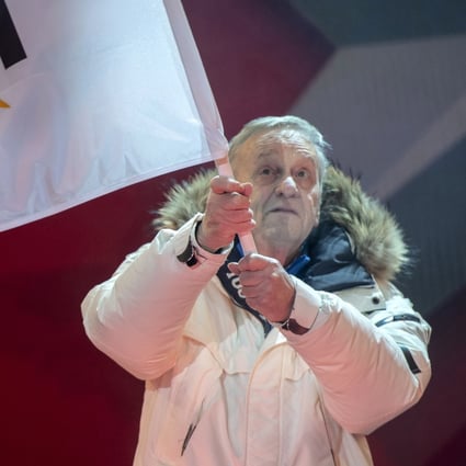 Gian Franco Kasper, president of the International Ski Federation, waves the FIS flag during the opening ceremony of the FIS Alpine Skiing World Championships in Are, Sweden, on Monday. Photo: EPA