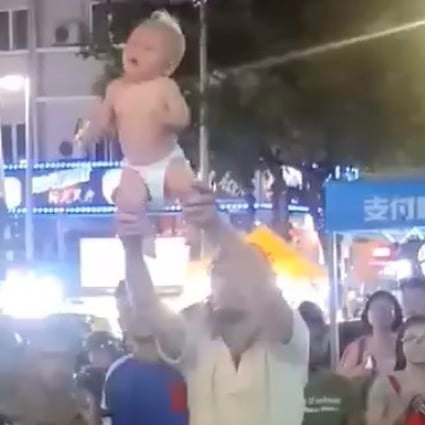 A still from the video showing the Russian man swinging his baby around in Kuala Lumpur. Photo: Facebook
