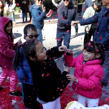 Children play with exploded firecracker wrappers while ushering in Lunar New Year, on Tuesday, in San Francisco, California. San Francisco will have a month-long celebration as part of the Year of the Pig. Photo: Getty Images/AFP