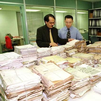 Then Government Records Services director Simon Chu (left) and his staff appraise government records transferred to the Public Records Office in 1999. Photo: Information Services Department