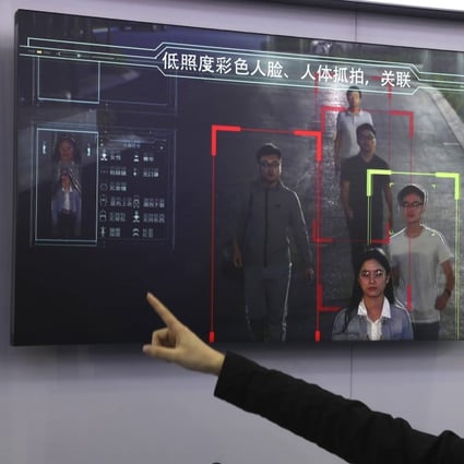 A saleswoman introduces human identification technology from state-owned surveillance equipment manufacturer Hikvision on a monitor at Security China 2018 in Beijing. Photo: AP