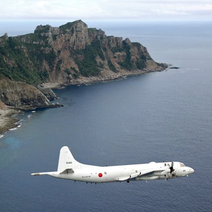 A Japanese surveillance plane flies over the disputed islands in the East China Sea, called the Senkaku in Japan and Diaoyu in China. Photo: AP
