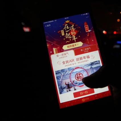 A man uses his mobile phone to grasp a digital lai see, or digital red packet, in a taxi car in Beijing. Photo: Simon Song