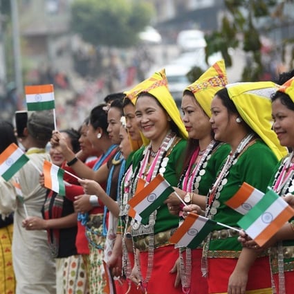 People in Arunachal Pradesh wave flags to welcome Indian Prime Minister Narendra Modi. Photo: Twitter