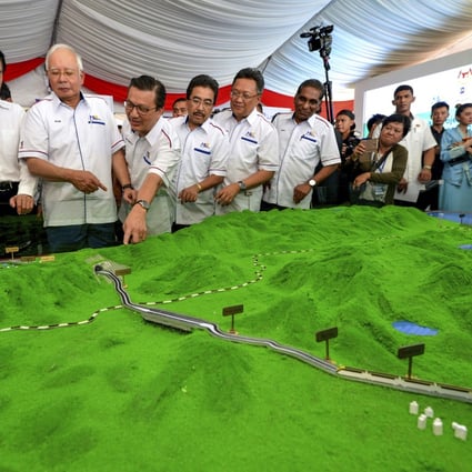 Malaysia’s former prime minister Najib Razak (third left) looks at models of the East Coast Rail Link in 2017 - the project was later scrapped by his successor Mahathir Mohamad because the US$20 billion cost of the deal was too much for the country to bear. Photo: AP