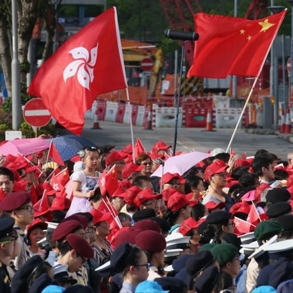 People wave the Chinese and Hong Kong flags at a flag-raising ceremony at the Golden Bauhinia Square in Wan Chai to mark the 21st anniversary of the establishment of the Hong Kong Special Administrative Region on July 1 last year. Photo: David Wong