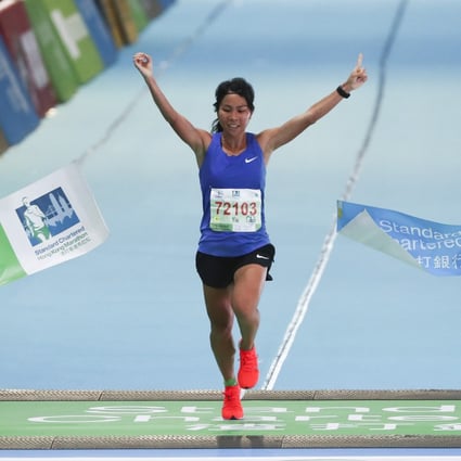 Christy Yiu Kit-ching wins the women’s half marathon at the Standard Chartered Hong Kong Marathon. Photos: Nora Tam
