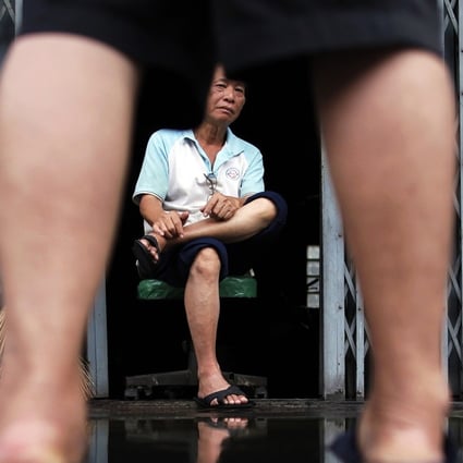 Residents discuss the situation in flooded Chinatown, central Bangkok, in 2011. Pitchaya Sudbanthad’s novel Bangkok Wakes To Rain recreates life in the flood-prone city. Photo: Reuters