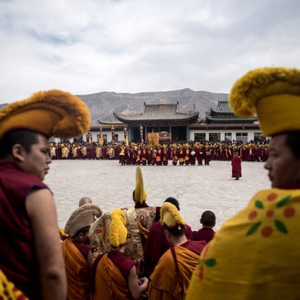 Tibetan Buddhist monks pray during a ceremony at a monastery in Qinghai. A county in the province has banned children from attending language classes taught by monks. Photo: AFP