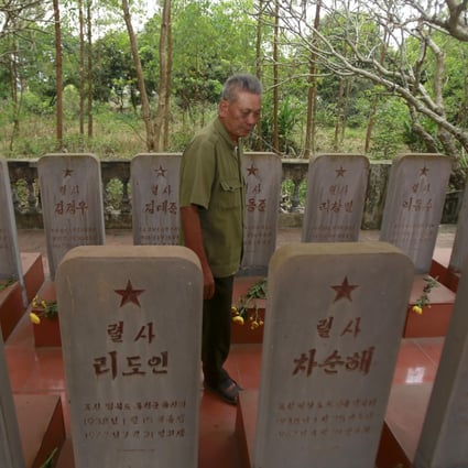 War veteran Duong Van Dau among the headstones at a memorial for North Korean fallen pilots in Bac Giang. Photo: AP