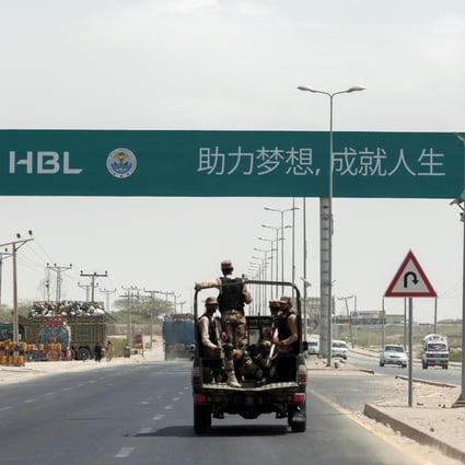 Security forces near a sign that reads “First Pakistani Branch in China” in Gwadar. Photo: Bloomberg