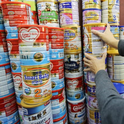 Tins of infant powder formula are seen at a pharmacy in Sheung Shui. 11DEC13