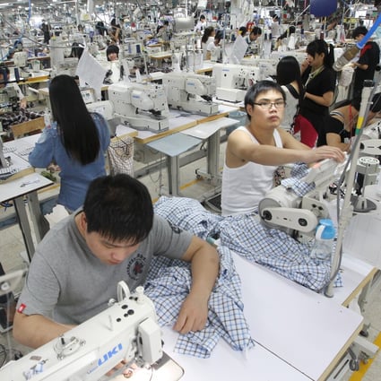 Staff on a shirt production line at a textile factory in Dongguan, Guangdong. Young migrant workers are increasingly looking to the services sector for jobs. Photo: Edward Wong