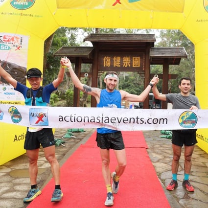 Bin Lang, Vlad Ixel and Adrian Konareff cross the finish line in joint second after losing their way thanks to markers being sabotaged in the Sai Kung 50. Photo: Action Asia