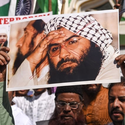 Indian Muslims hold a scratched photo of Jaish-e-Mohammad chief Maulana Masood Azhar during a protest in Mumbai after a suicide bomb attack in Kashmir by the group. Photo: AFP