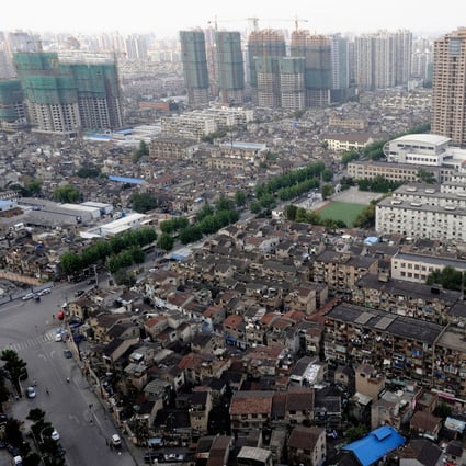 A view of the Hongkou district in Shanghai, with apartments under construction in the background, and traditional low rise homes in the foreground, as of October 8, 2009. Photo: Alamy