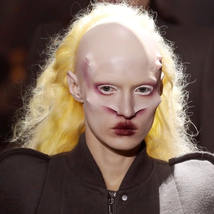 A model with grotesque, alien-style nose cartilage, horns and make-up and a billowing yellow wig, catches the eye on the catwalk while presenting creations from Rick Owens’ fall/winter 2019/20 collection show at Paris Fashion Week on Thursday. Photo: AFP