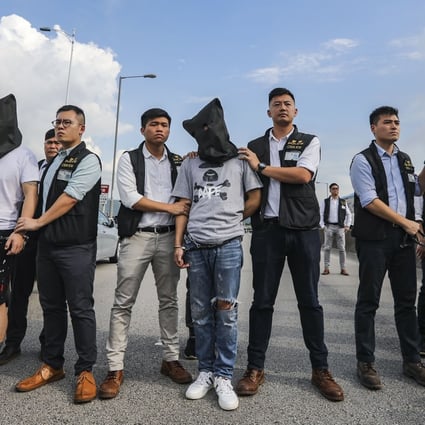 Guangdong provincial police hand over three robbery suspects to Hong Kong police officers in August 2018 through an informal arrangement. Photo: Edward Wong